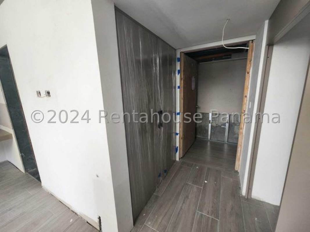 Interior hallway featuring built-in cabinetry and modern tile at Coco del Mar Sky