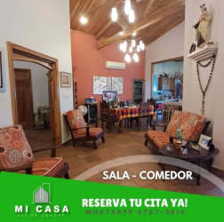 Traditional gazebo with tiled roof surrounded by lush garden and large lawn in Penonomé