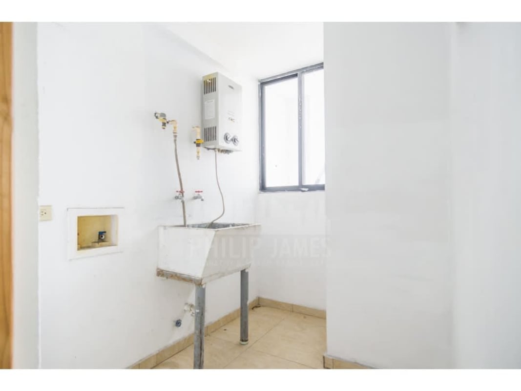 Kitchen with granite counters, wooden cabinets in apartment Condado del Rey Panama