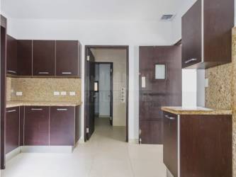 Modern kitchen with granite countertops and wood cabinets in Embassy Village Clayton