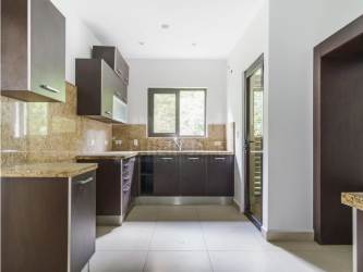 Covered balcony overlooking lush tropical vegetation at PH Embassy Village Clayton