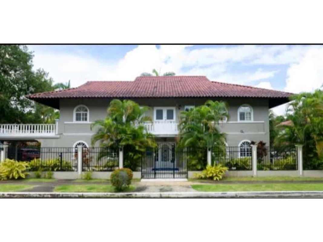 Two-story luxury mansion with red tile roof lush gardens and large lawn Albrook Panama