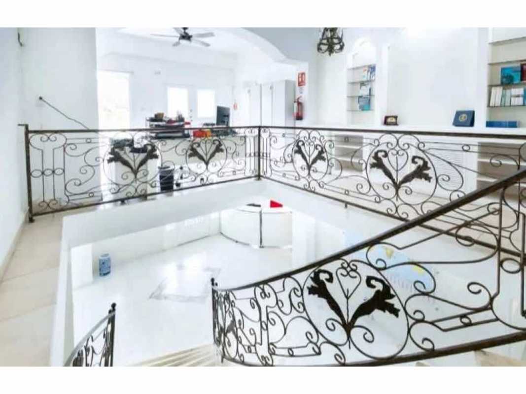 Upper landing with ornate railing and Mediterranean details in luxury Albrook mansion for embassies