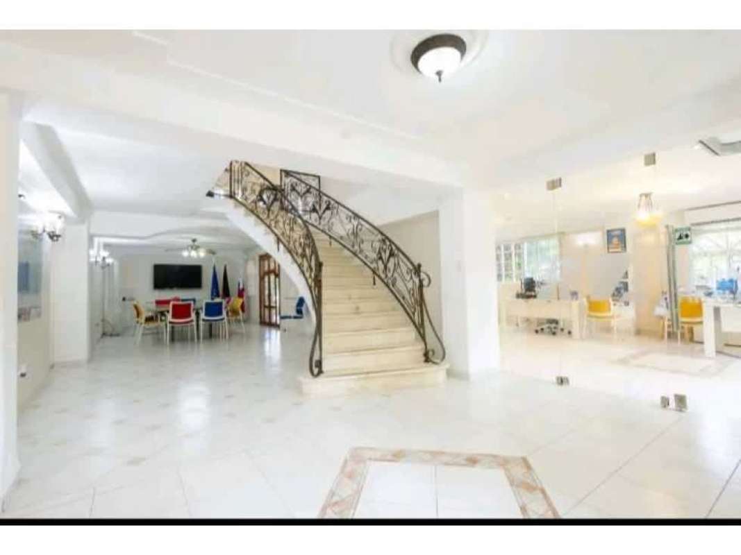 Lobby area with elegant staircase and bright design in luxury Albrook residence