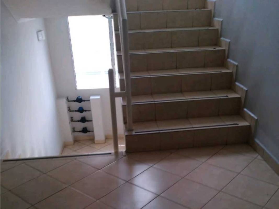 Indoor stairwell with metal railing and window at PH Bosque del Castilla Panama City