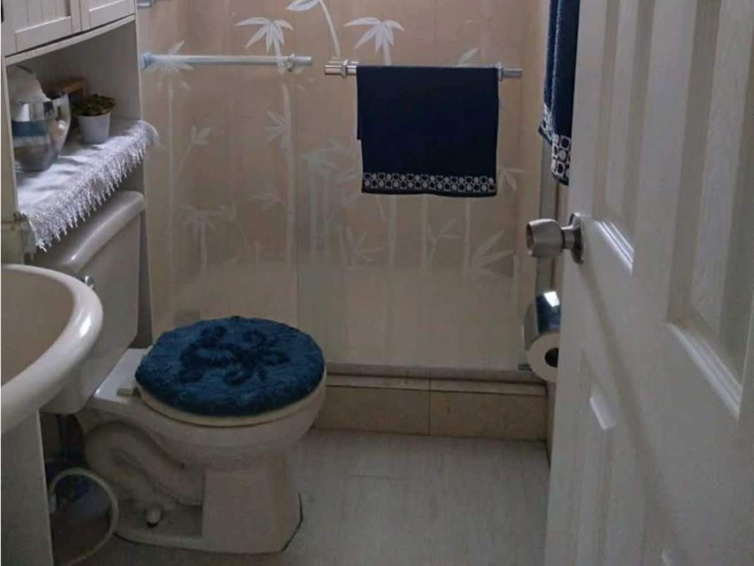 Contemporary kitchen with white cabinets and geometric tile backsplash at PH Bosque del Castilla Panama City