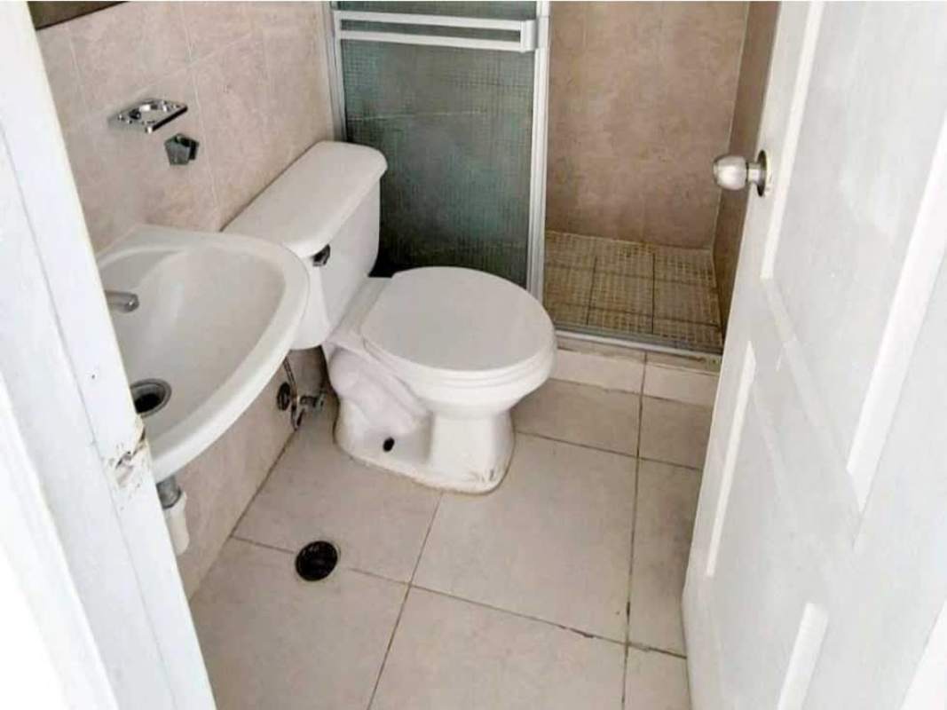 Compact bathroom tiled with shower stall and sink in duplex home Pedregal Panama