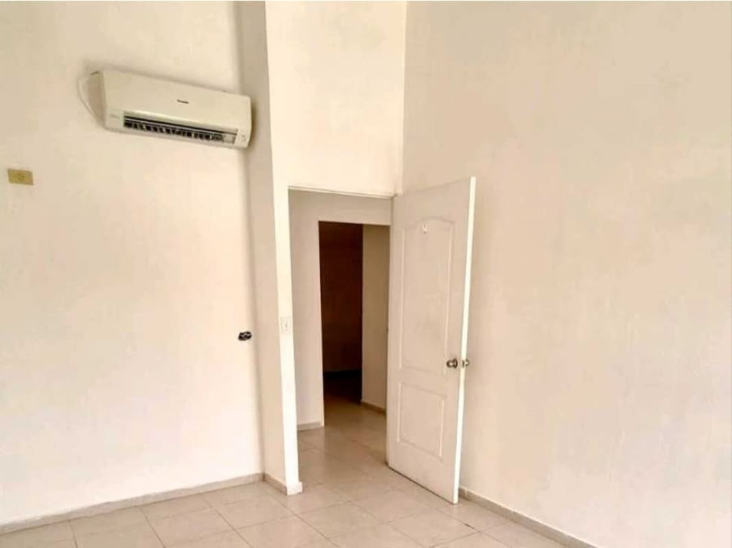 Main bedroom with split AC ceramic floors and neutral walls for sale Pedregal Panama