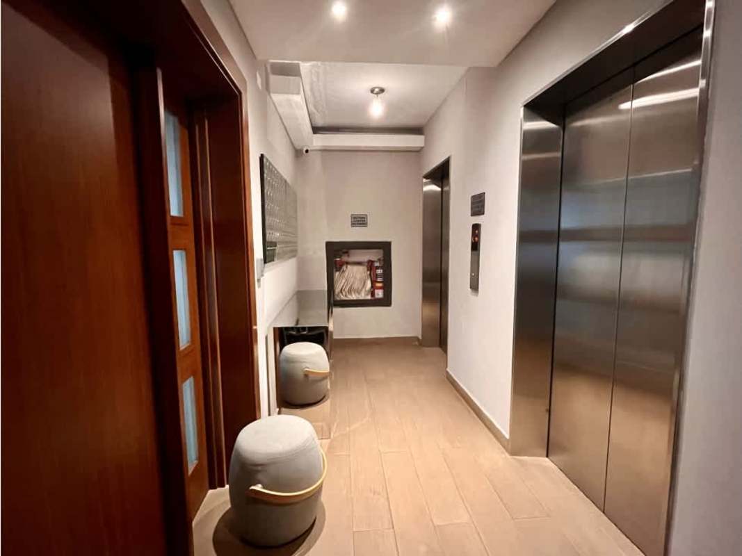 Modern island kitchen with stainless appliances and tile floors in luxury penthouse Panama