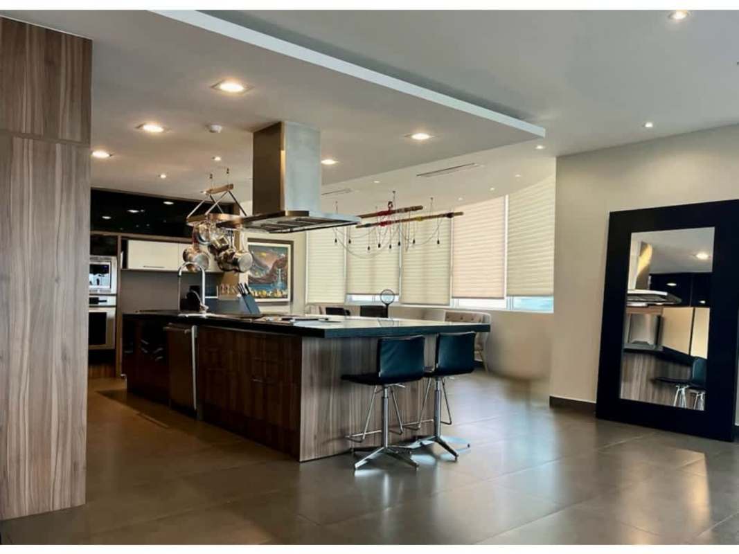Contemporary kitchen with island, stainless appliances, breakfast bar at PH Vista Park penthouse Panama