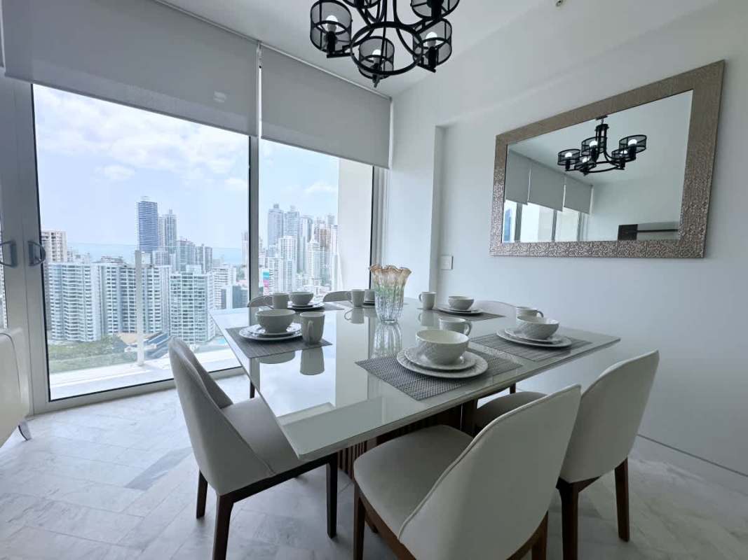 Bedroom with built-in closet floor-to-ceiling windows overlooking Panama skyline PH Wanders & Yoo