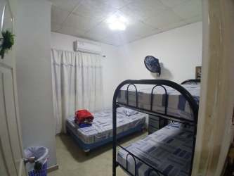 Bathroom with shower curtain, tile walls, pedestal sink in Barriada La Cresta Colón