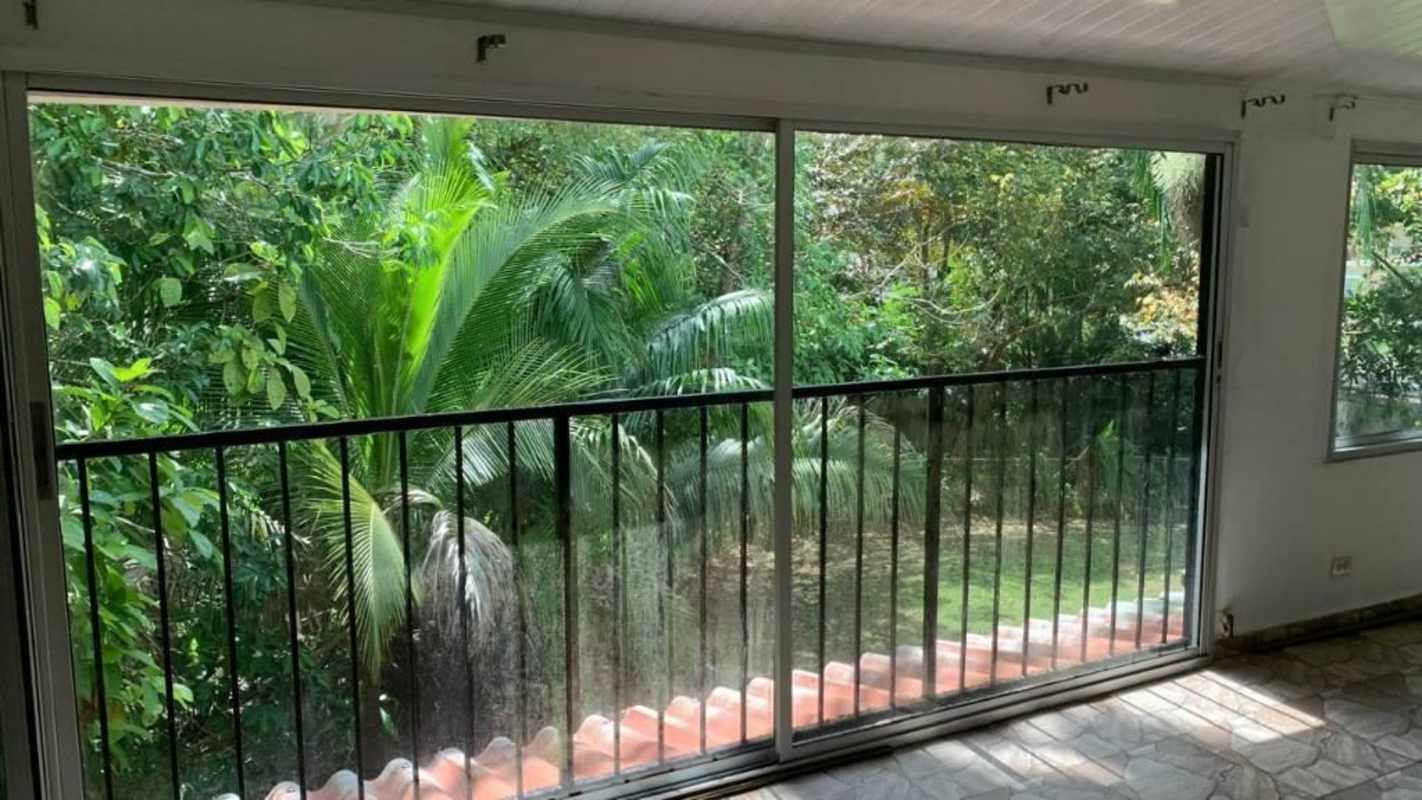 Large windows sliding glass doors tropical jungle view residential Clayton Panama rental