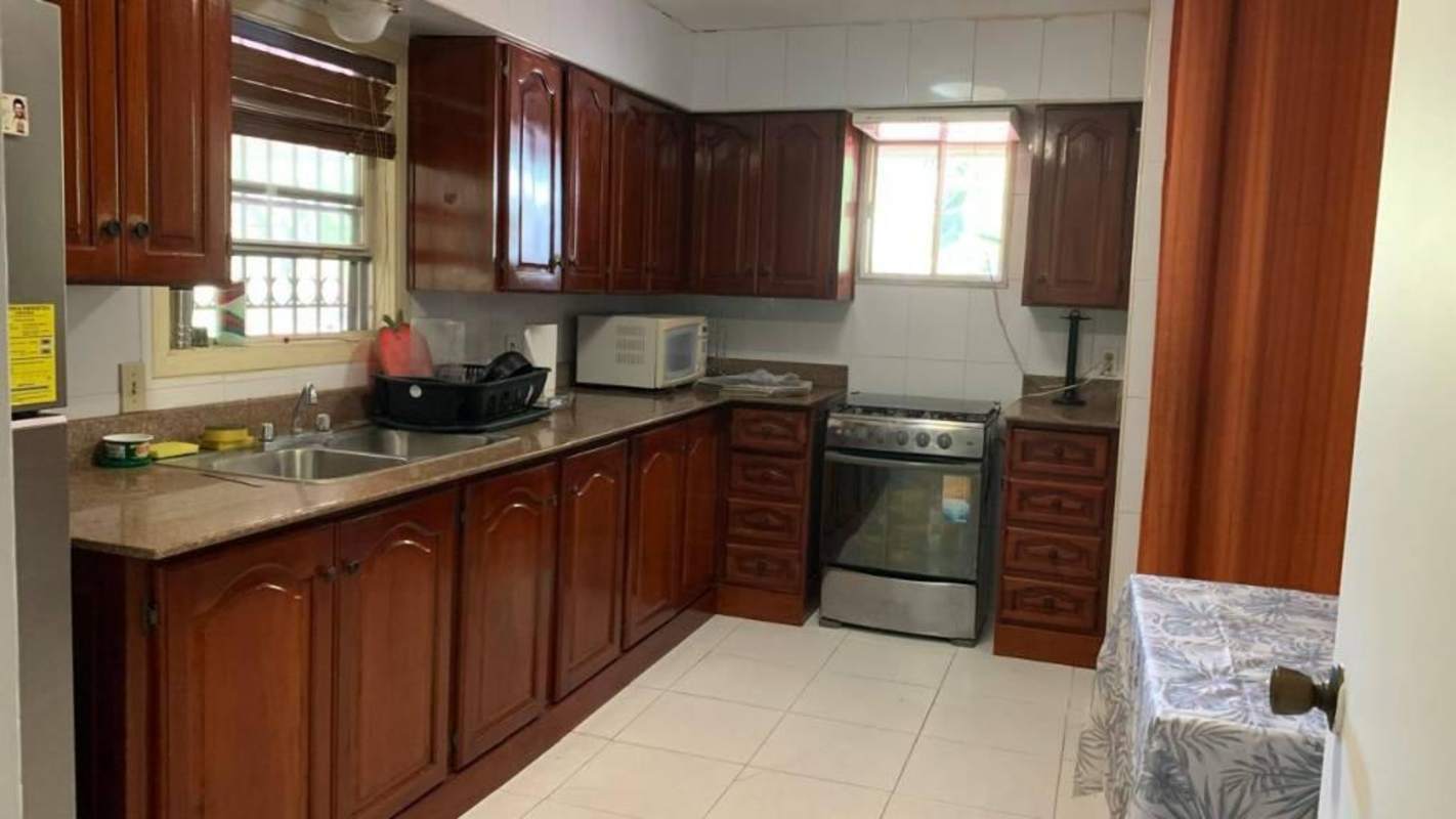 Traditional kitchen with wood cabinets granite countertops double sink microwave Clayton Panama