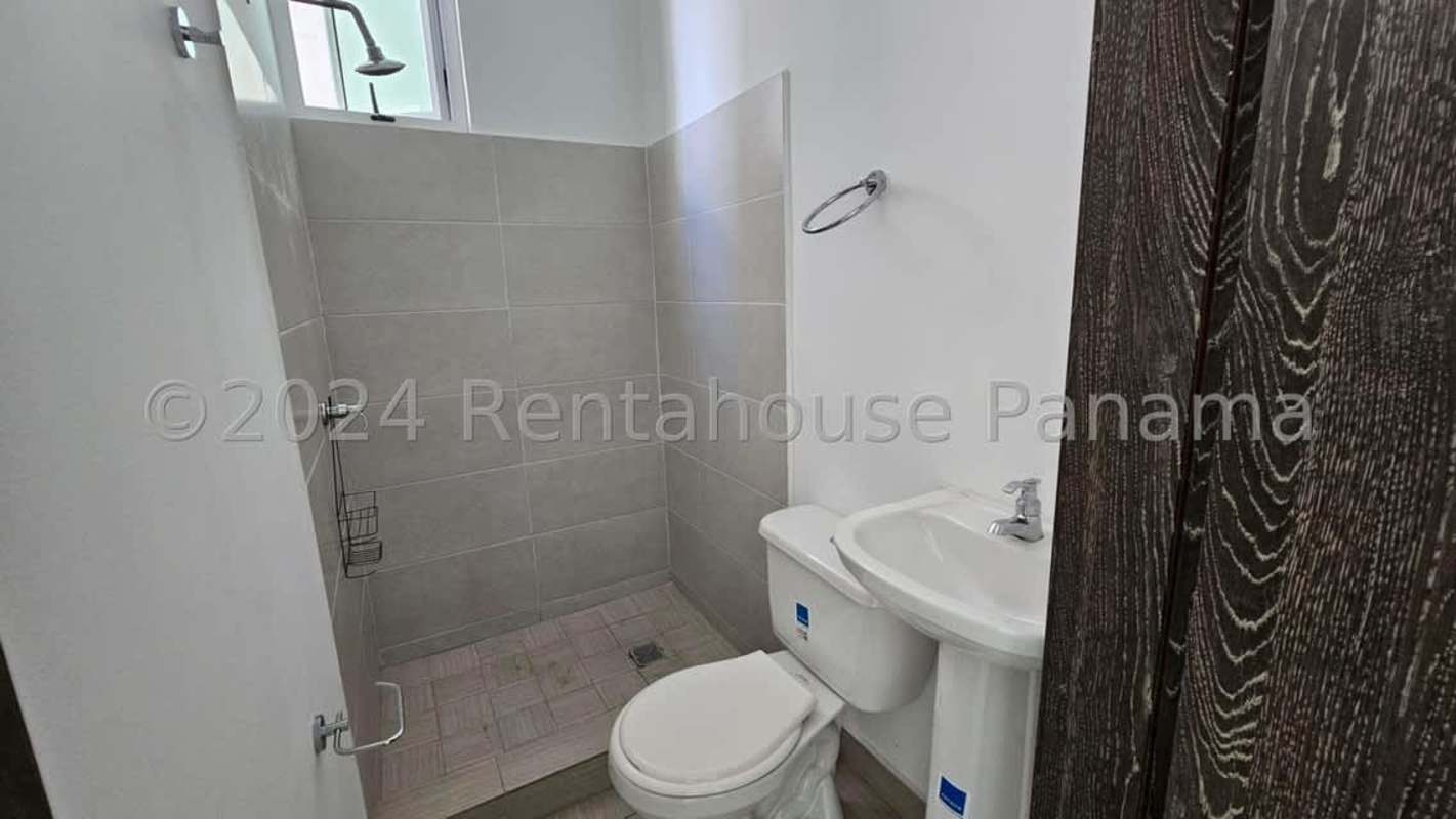 Modern bathroom with glass shower and stone vanity at PH Pacific Point Costa del Este Panama