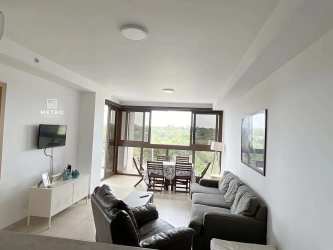 Modern living room opening to balcony with sea view at Corona del Mar Playa Corona