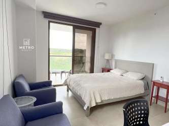 Bedroom with glass doors opening to oceanfront balcony in Corona del Mar Playa Corona Panama