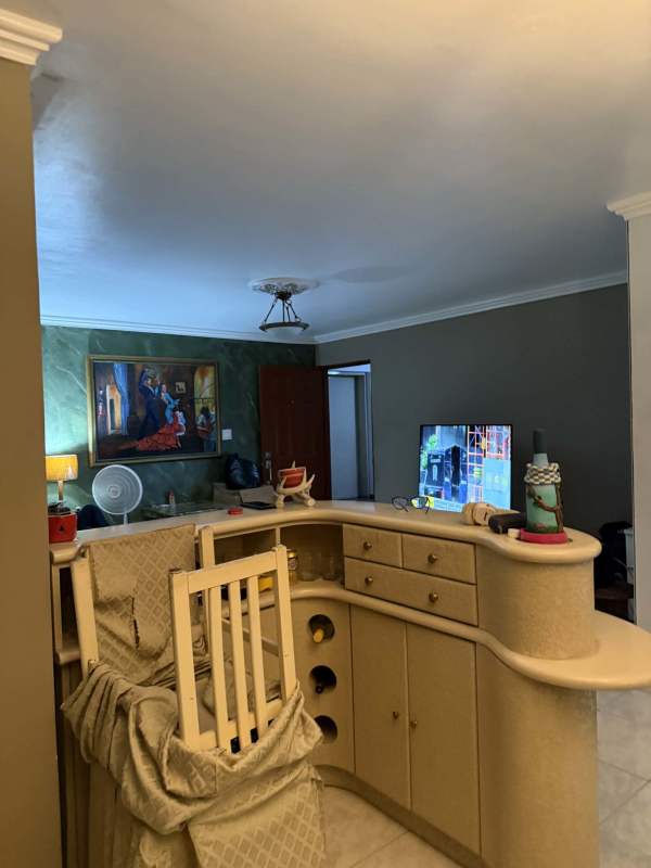 Kitchen with U-shape granite counters, wood cabinets and appliances in PH Mirabel Punta Paitilla Panama City