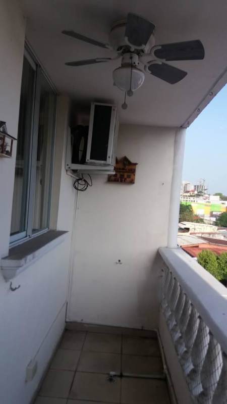 Covered balcony with ceiling fan, AC unit and city skyline view in PH Río Pison Betania Panama City