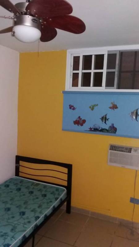 Cozy bedroom with bed, air conditioner, window shade, and ceiling fan in PH Río Pison Betania Panama City