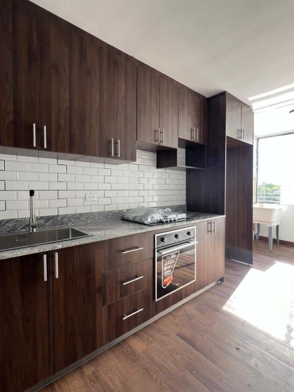Modern kitchen with granite countertops, subway backsplash, wooden cabinetry in PH Dorasol El Dorado Panama
