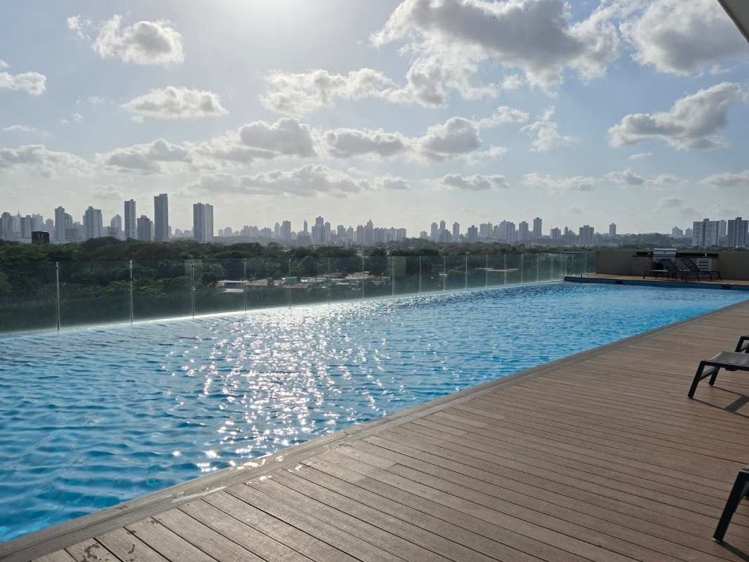 Bright living room with sectional sofa and city views at PH Bali Costa del Este