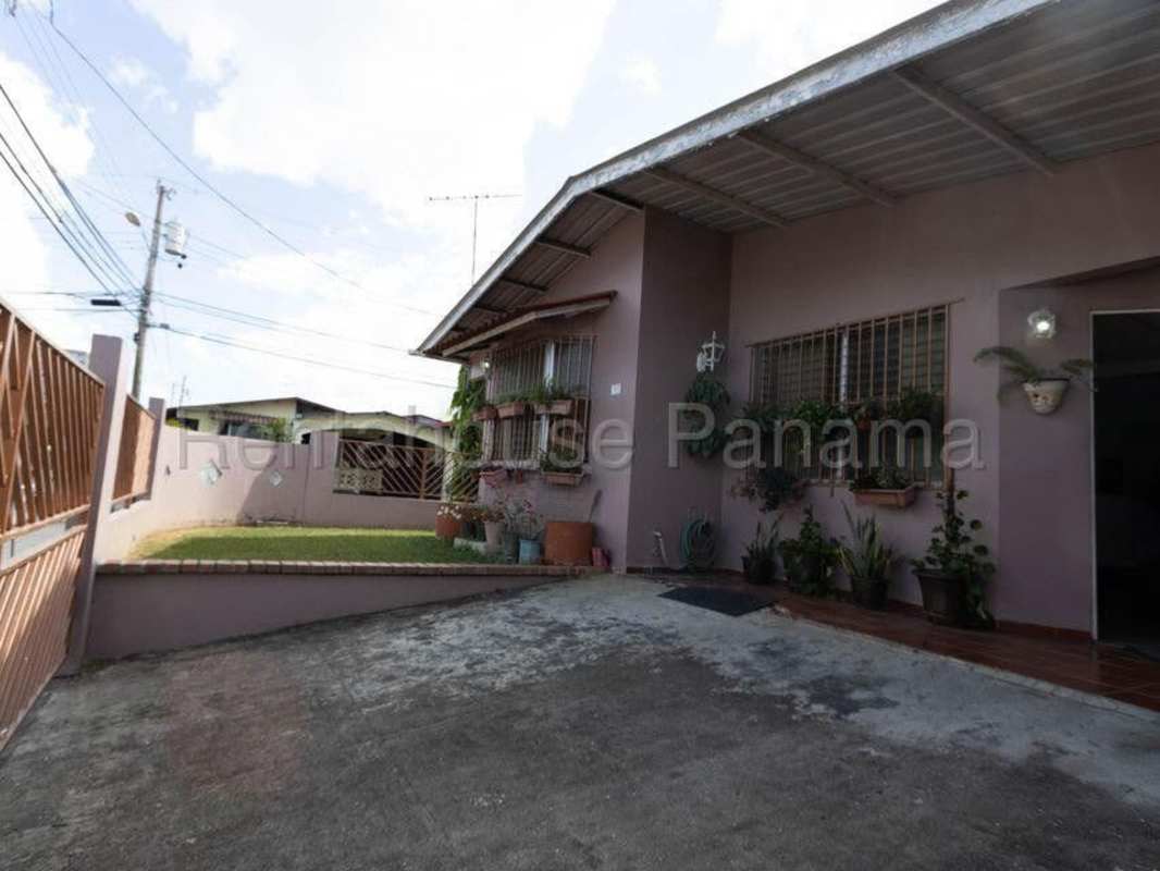 Spacious tiled living area with windows, fan, and open layout Villa Lucre Panama