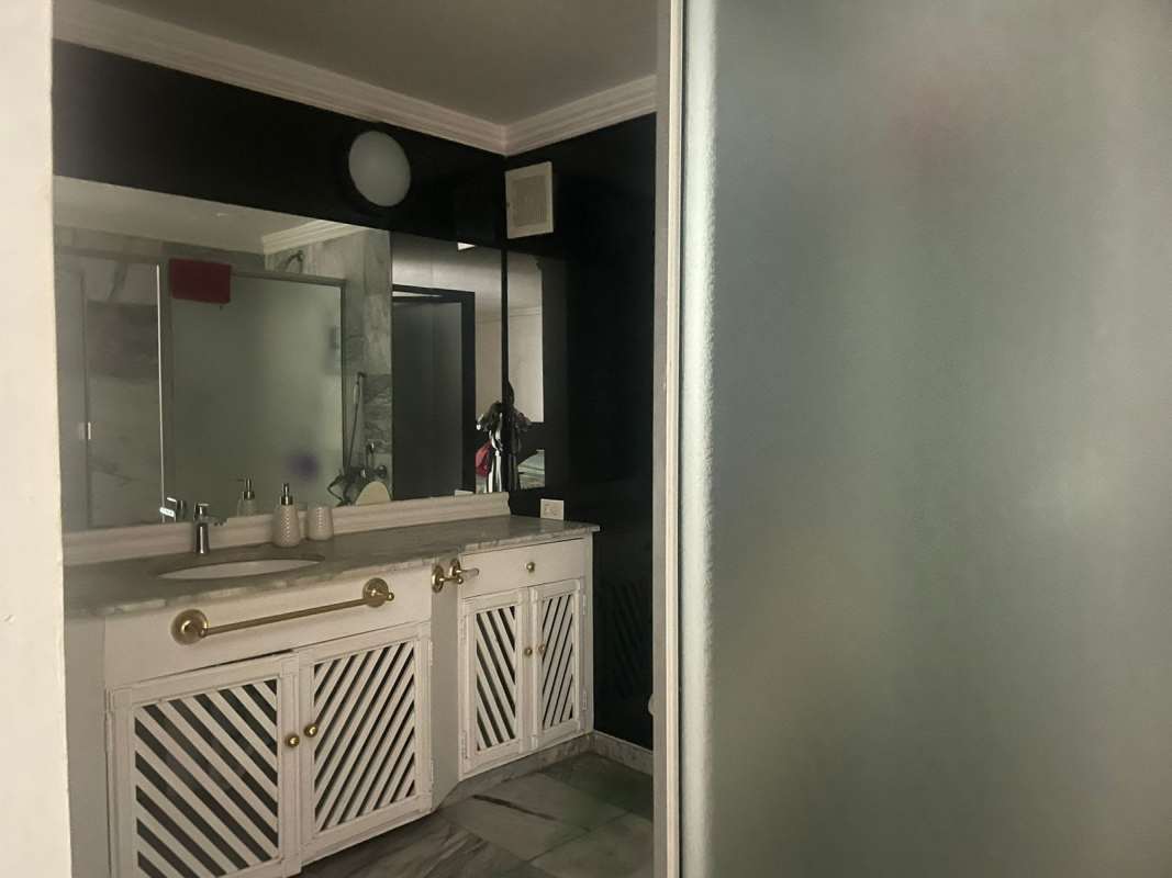 Bathroom with large mirror vanity marble counter glass shower PH Las Hadas Panama City