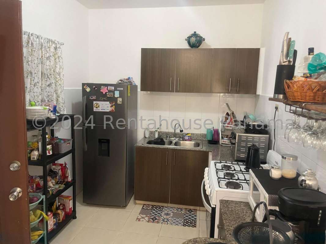 Large covered terrace with bar overlooking spacious backyard garden in PH Las Cumbres Panama