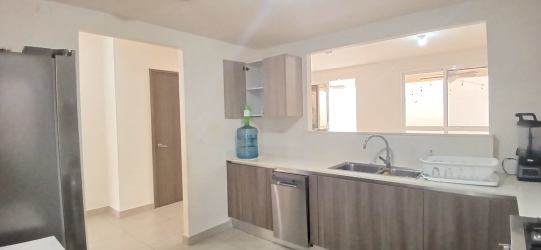 Bright living area with glass sliding doors to covered terrace in PH Bosques del Pacífico Panama Pacifico