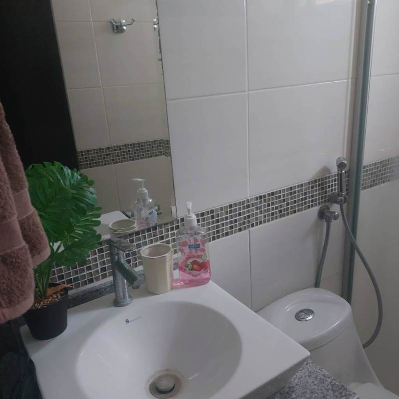 Compact modern bathroom with sink granite countertop and glass shower divider Bell View Tower Edison Park Panama City