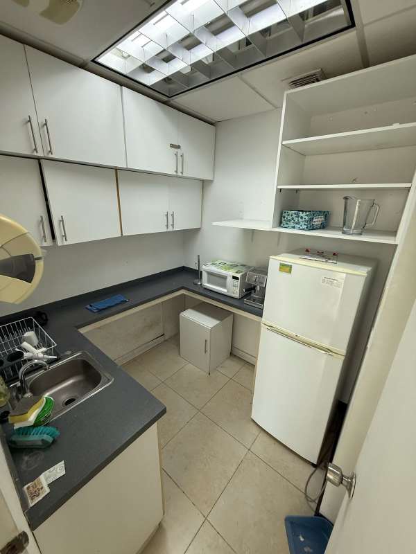 Compact kitchenette with cabinetry and appliances PH BICSA Tower Panama