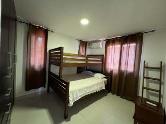 Dining room with air conditioning, pass-through window to kitchen in Panama Pacifico Woodlands