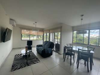Kitchen with granite counters, side-by-side refrigerator, microwave and stove at PH Midrise Woodlands
