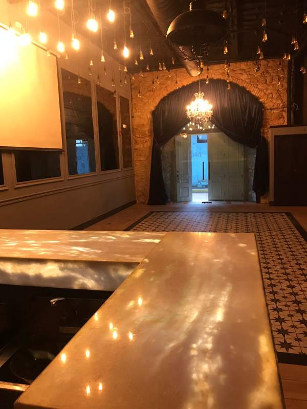 Stone wall glass entry pendant lights lounge space Casco Viejo commercial Panama City