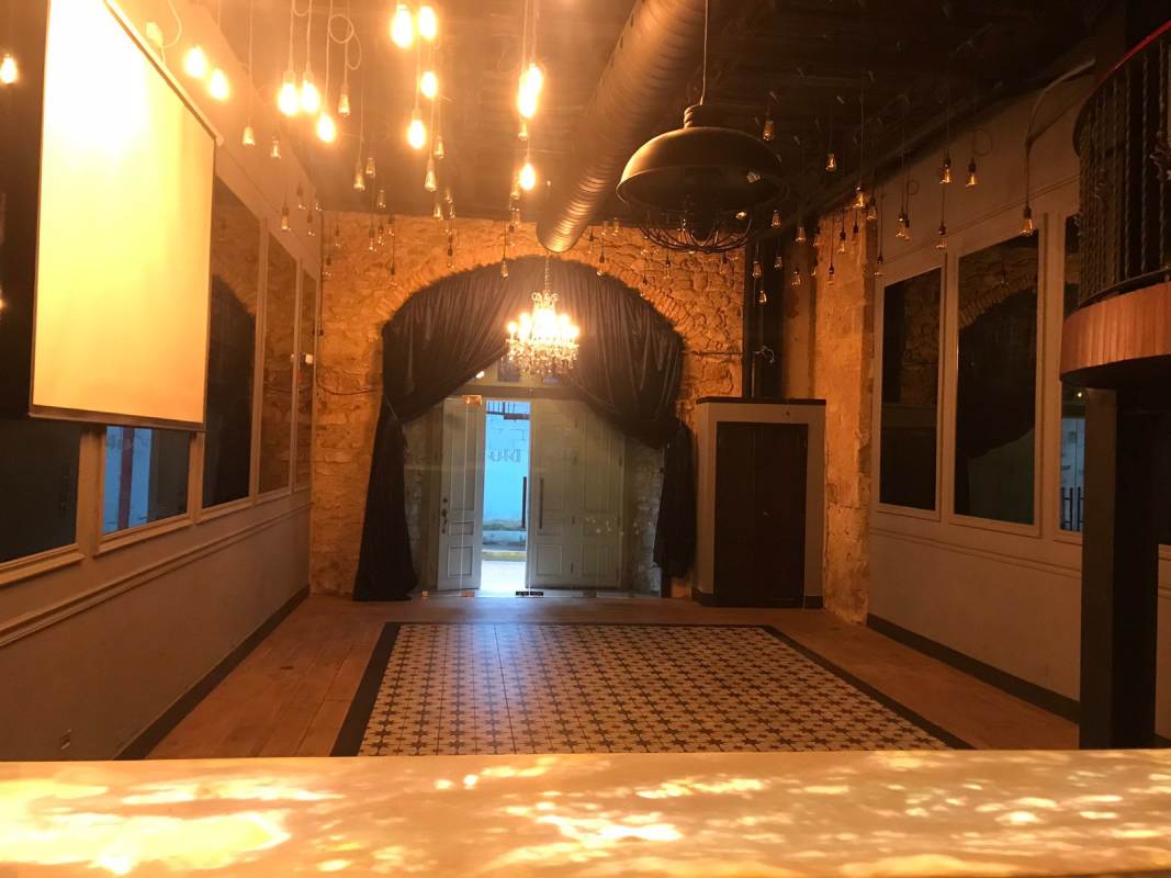 Vintage style interior with exposed brick arch chandelier Casco Viejo Panama