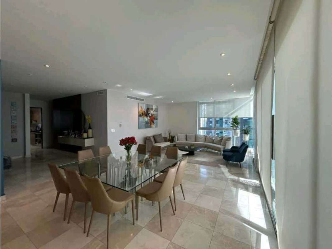 Modern spacious open living-dining room with floor-to-ceiling windows ocean view Pacific Village Panama