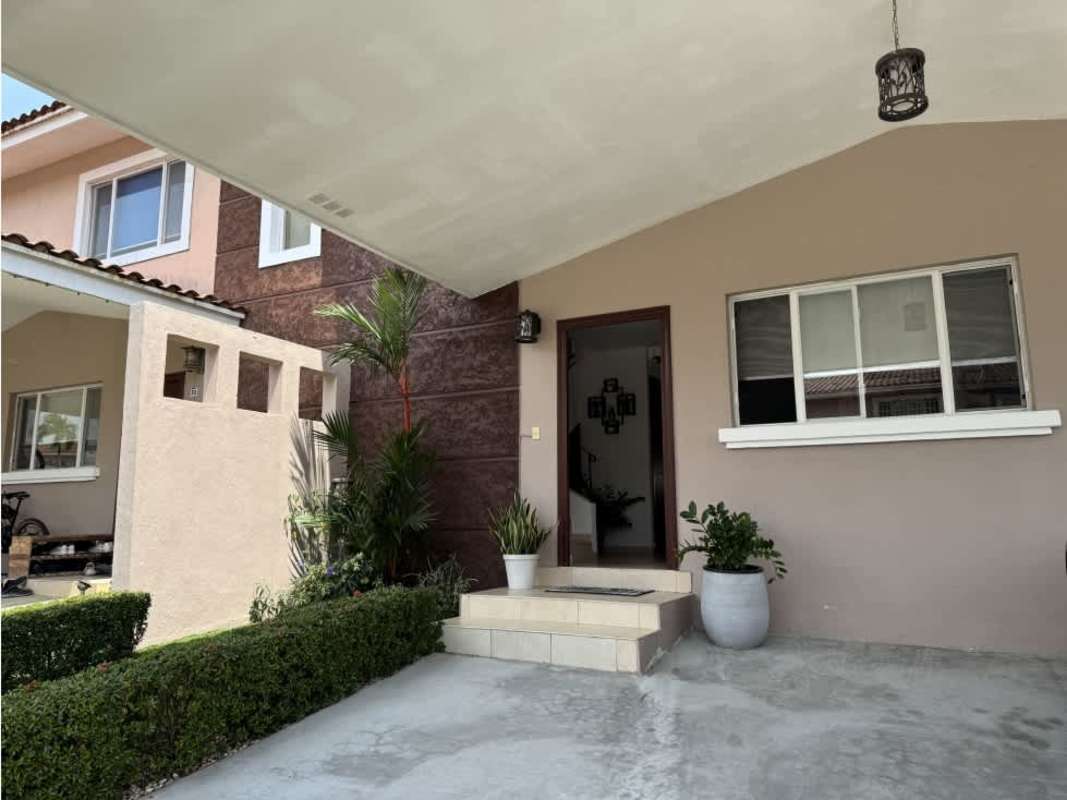 Covered entrance porch with planters and decorative lantern Villas del Golf II Panama