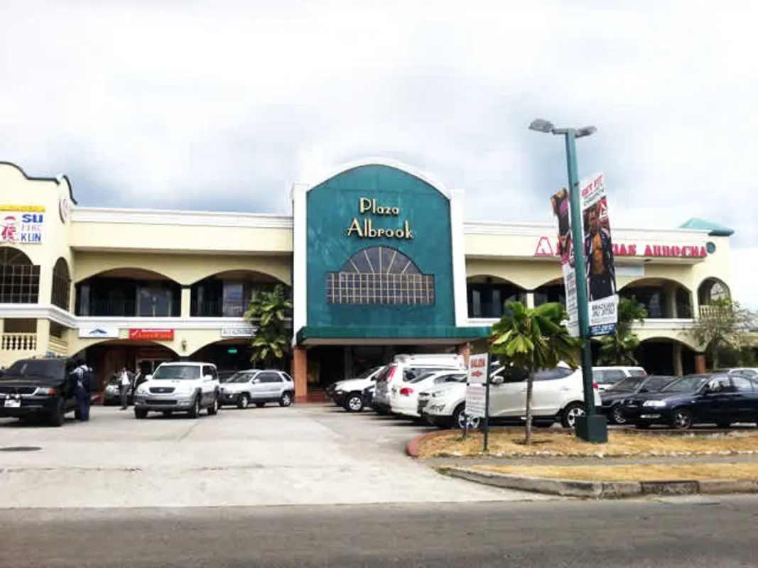 Two-story Mediterranean style plaza exterior with arches and parking at PH Plaza Albrook Panama