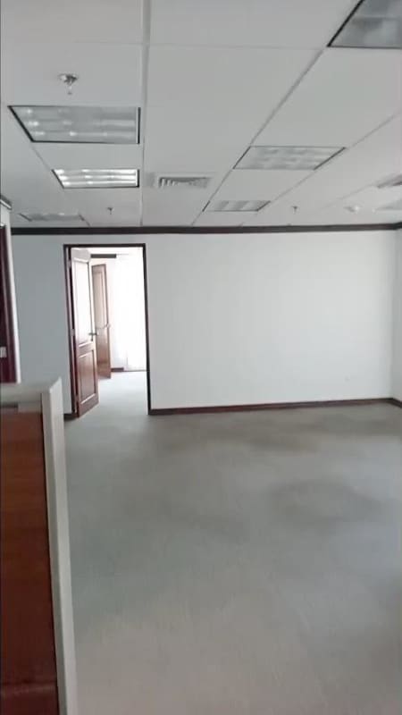 Empty commercial office with partition walls, carpet flooring, white walls, fluorescent lighting in Panama World Trade Center Marbella
