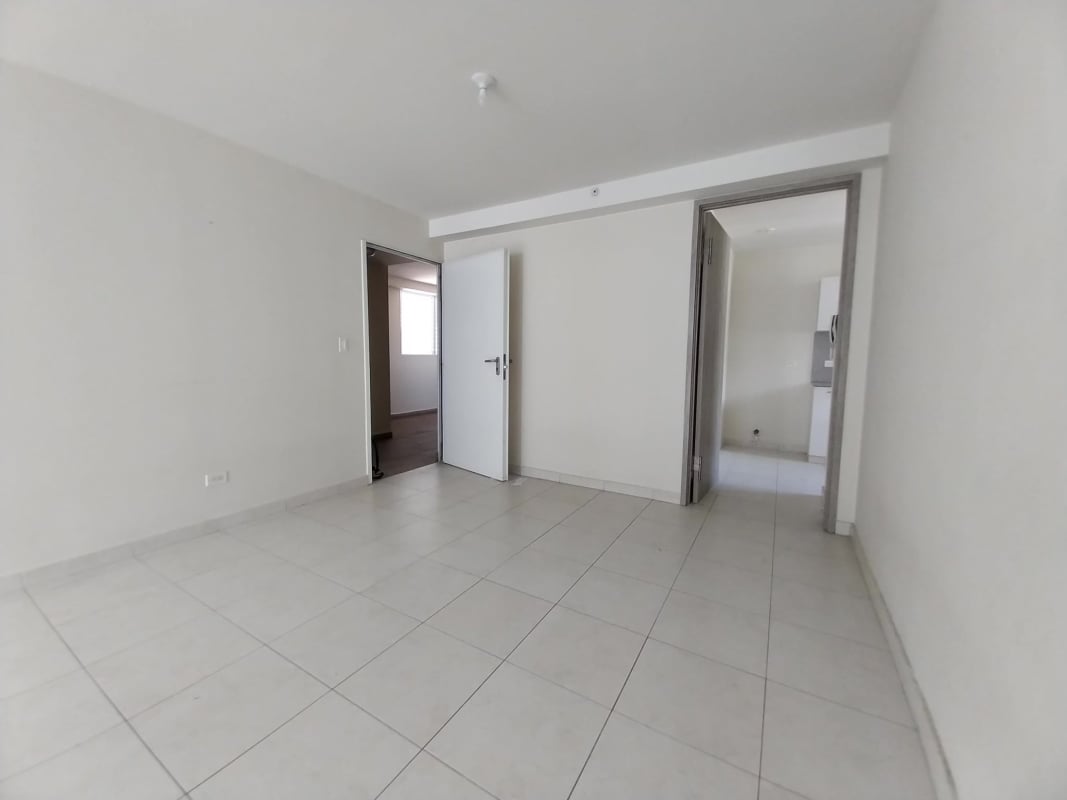 Spacious apartment living room with large sliding glass doors opening to balcony in Versalles II Panama