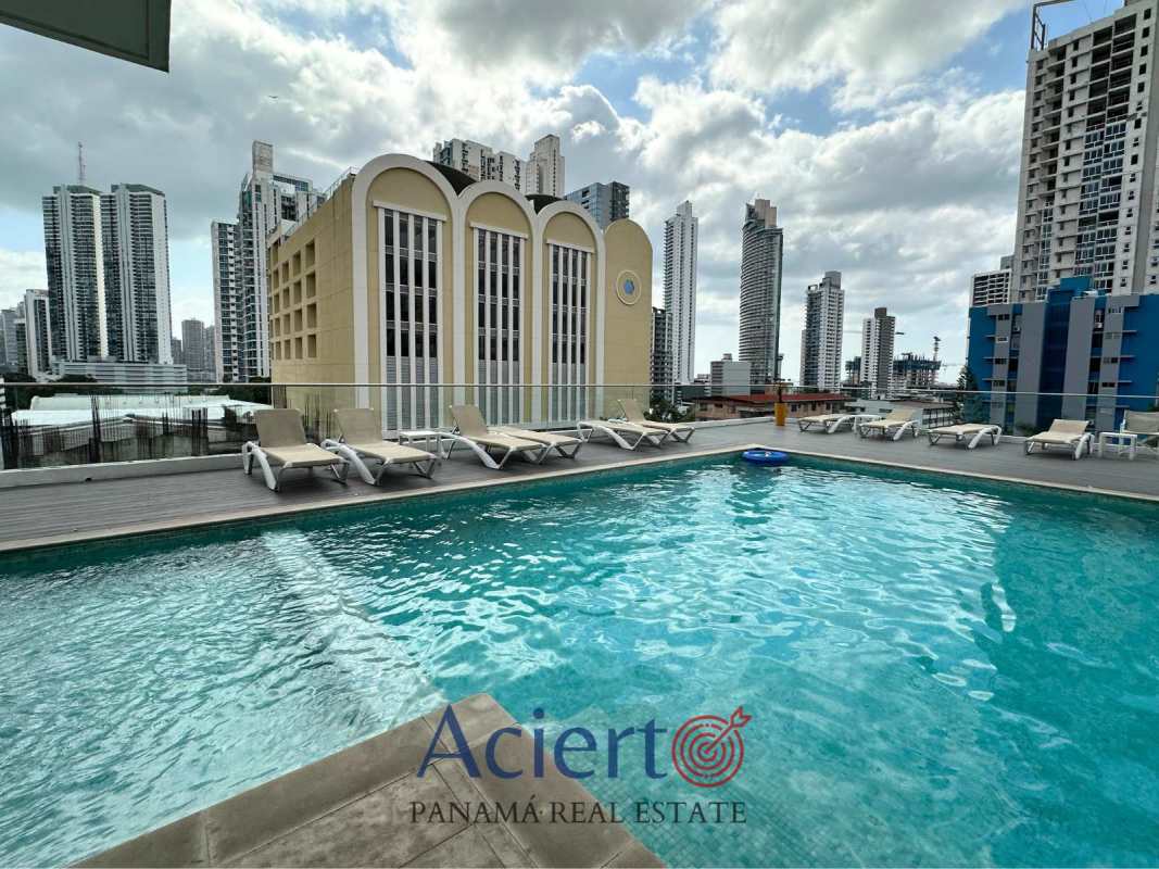 Rooftop swimming pool with skyline views and lounge chairs at PH Bella Vista Park Panama