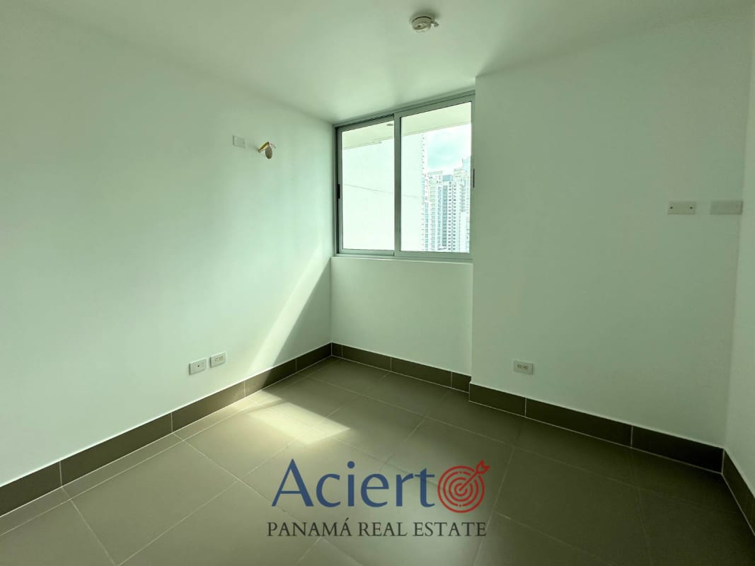 Empty bedroom with ceramic tile floor, large window with city view at PH Bella Vista Park Panama