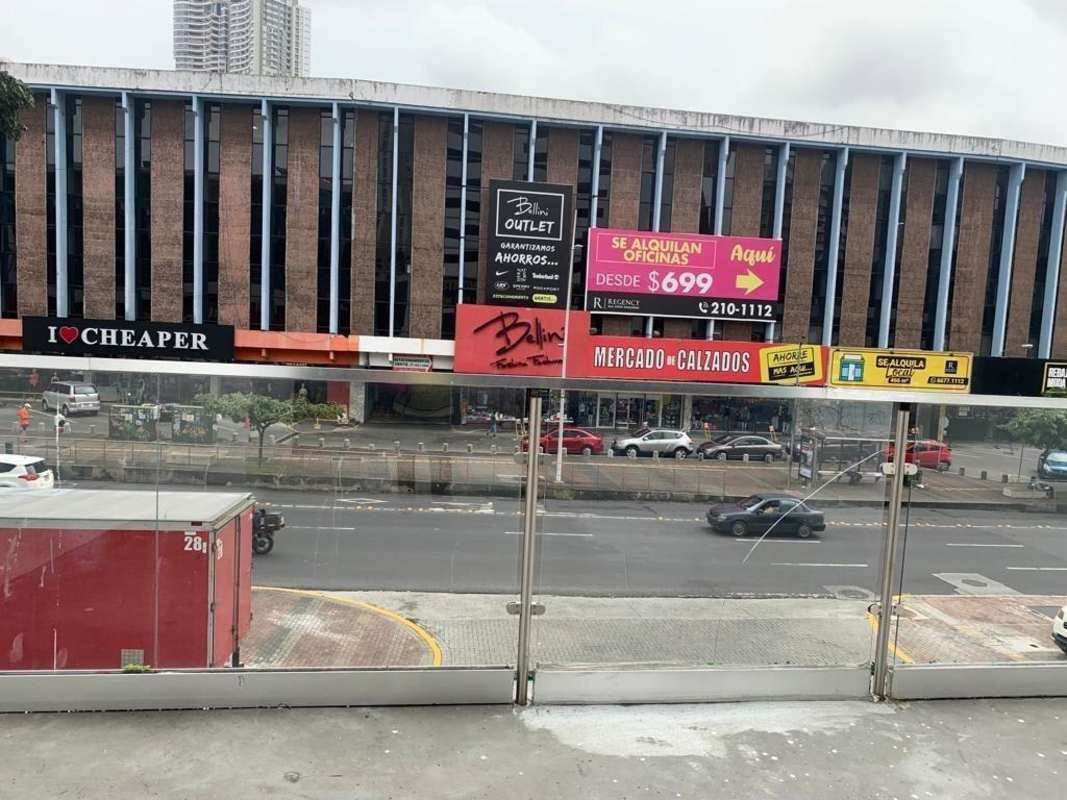 Modern commercial building with large glass windows colorful signage Worldwide Plaza Vía España