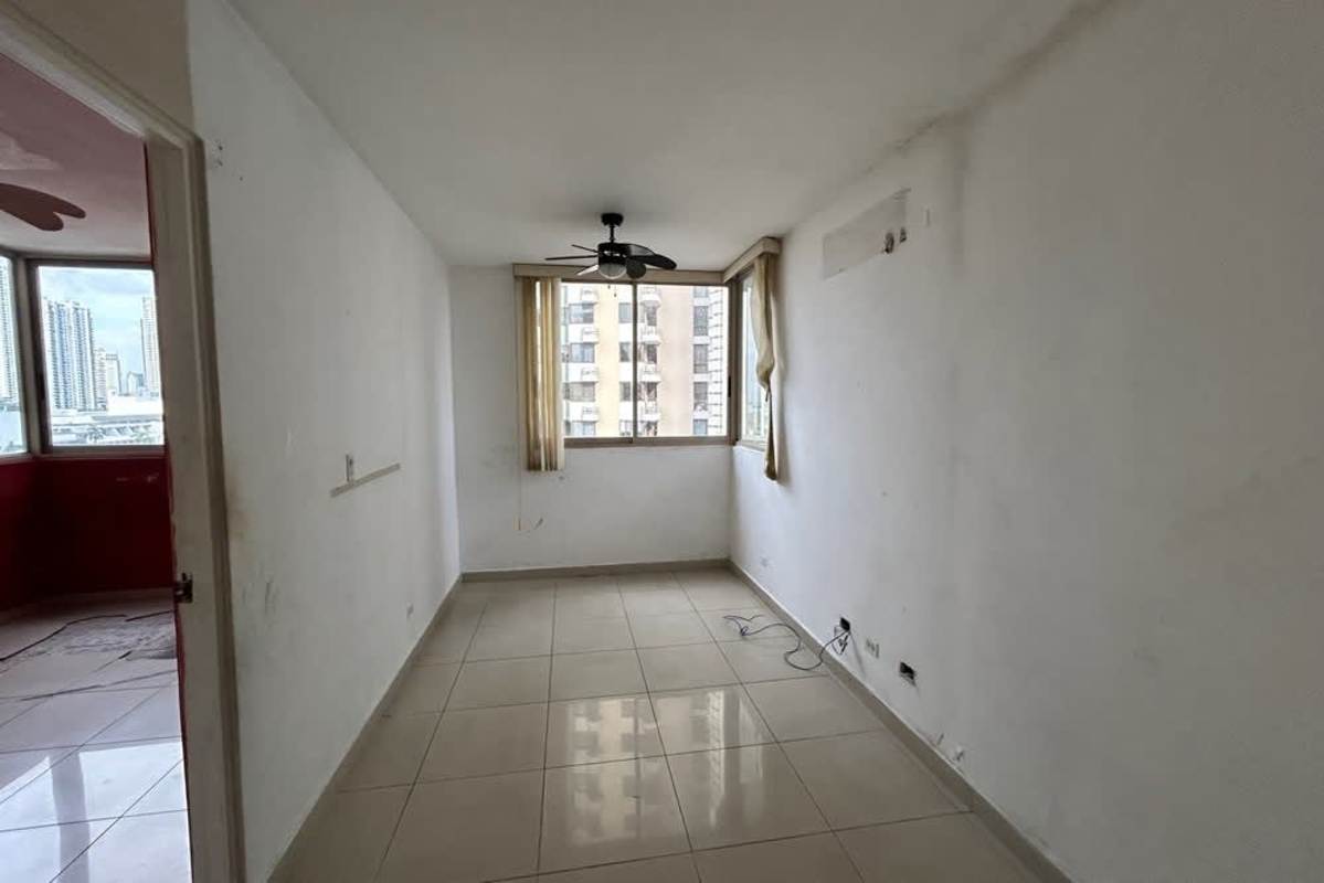 Bright living room with balcony access overlooking Panama City in PH San Francisco City Central.