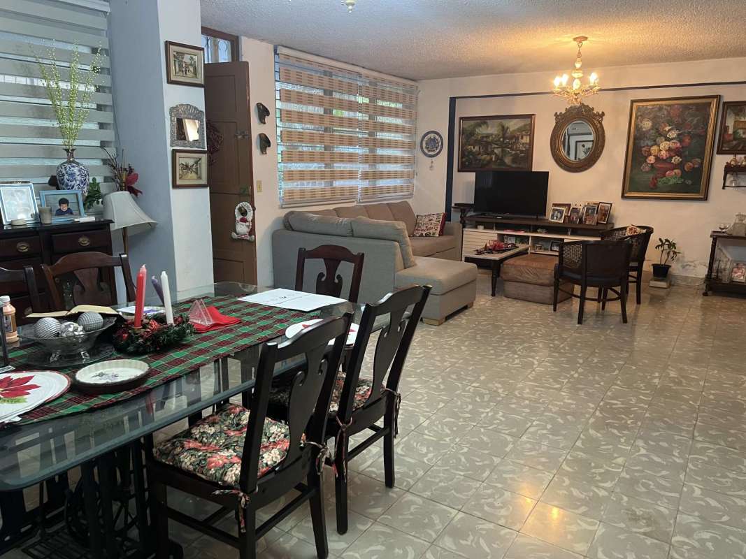 Dining and living with large windows, blinds and plants El Cangrejo Panama
