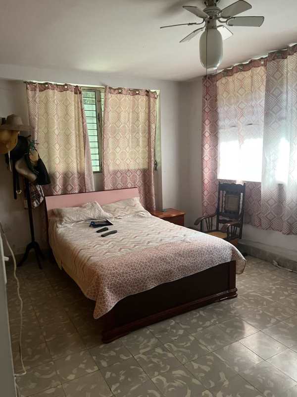 Large bedroom with ceiling fan, tiled floors and windows in PH El Cangrejo Residences Panama City