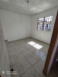 Minimalist living space with grilled window, white walls and simple design in David Panama apartment for rent