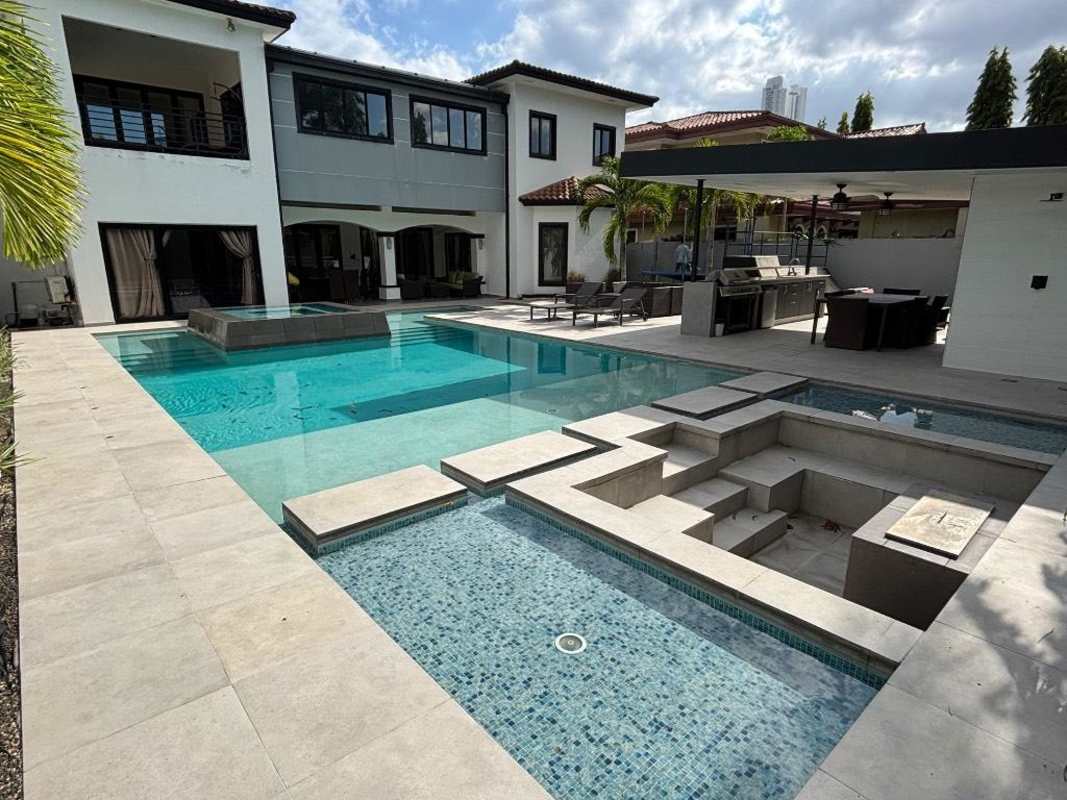 Large covered terrace patio overlooking swimming pool at PH Magnolia Costa del Este