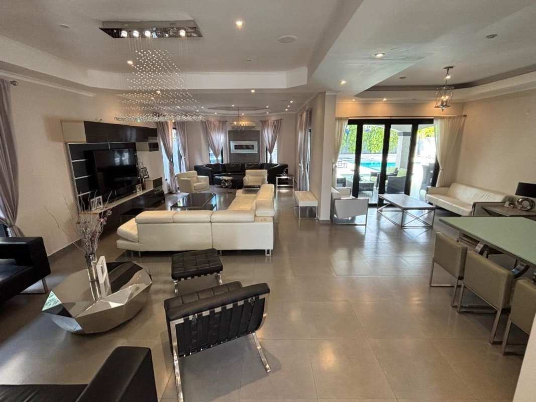 Modern kitchen with gray cabinetry, island, stainless appliances Costa del Este Panama